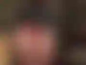 Maîtresse de culte au cul rond parfait en mini cuir et body en lycra brillant en dessous, associé à des collants brillants.