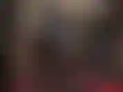 Une dominatrice en latex vêtue d'un legging noir moulant, de gants en latex rouge vif et d'un gros gode ceinture blanc. J'adore mon cul et ma bite.