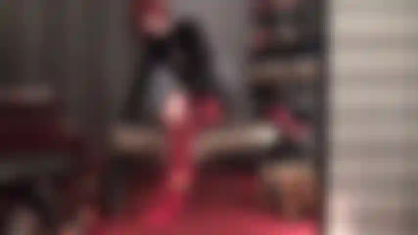 Wonderful legs tease in red stockings and pretty red pumps on black oil shine catsuit.