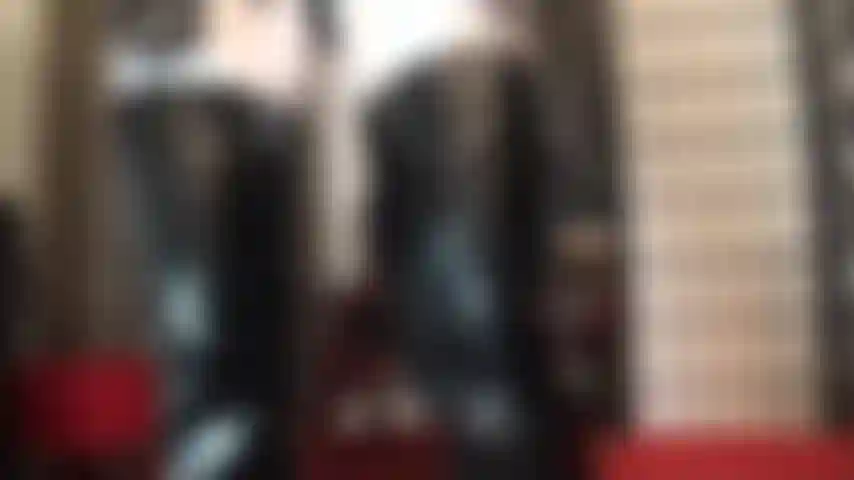 Tenue noire et blanche de bottes et gants fétichistes en pvc brillant associés à des collants en lycra blanc brillant.