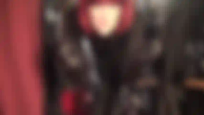 Maîtresse est habillée d'une jupe en cuir noir élégante, d'un chemisier en satin, de bottes à lacets et de longs gants en cuir, taquinant avec de merveilleuses jambes de collants soyeux en dessous.