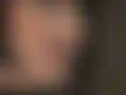 Perruque noire, rouge à lèvres rouge, langue qui taquine.