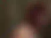 Une maîtresse en latex rouge et féroce avec une cravache.